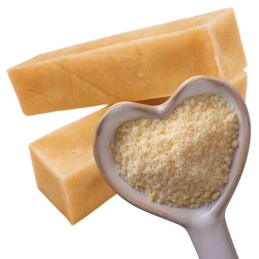 A colour image of 2 Yak bars and a heart shaped spoon holding finely grated yak cheese.