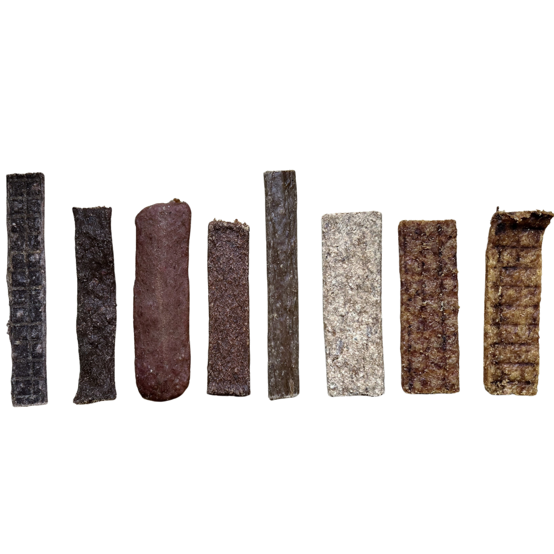 A colour image of a range of flat meaty strips in different colours shapes and sizes