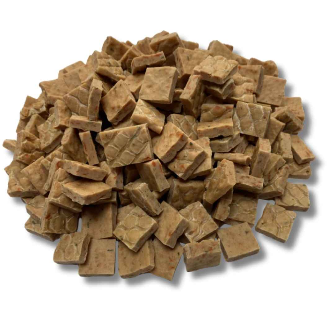 A colour image of square, flat natural dog treats.